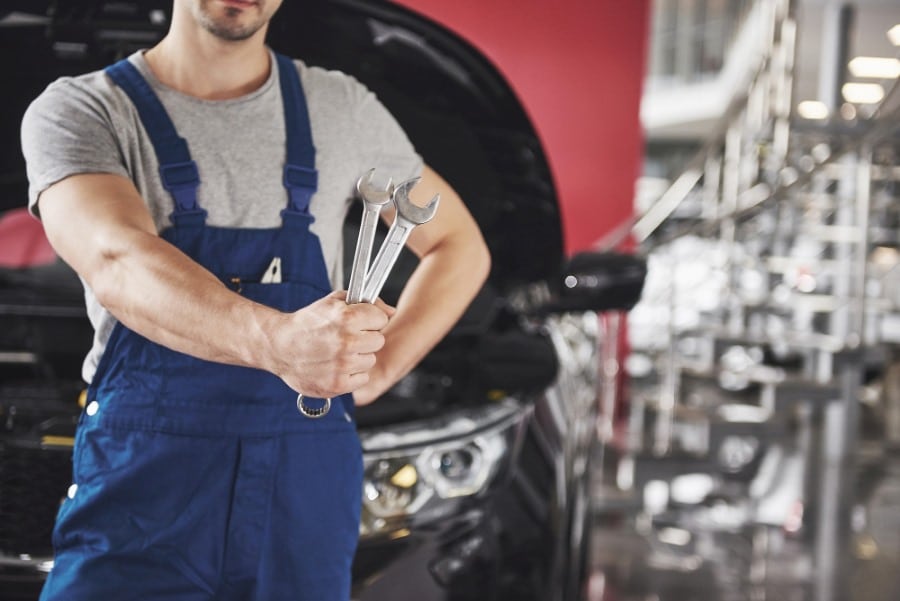 mechanic with tools in hand
