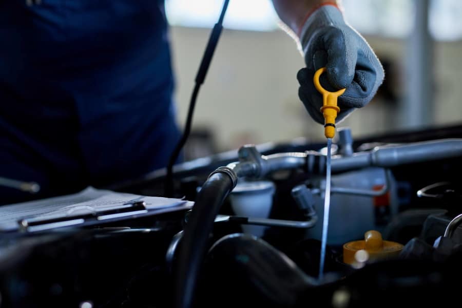 mechanic checking oil level