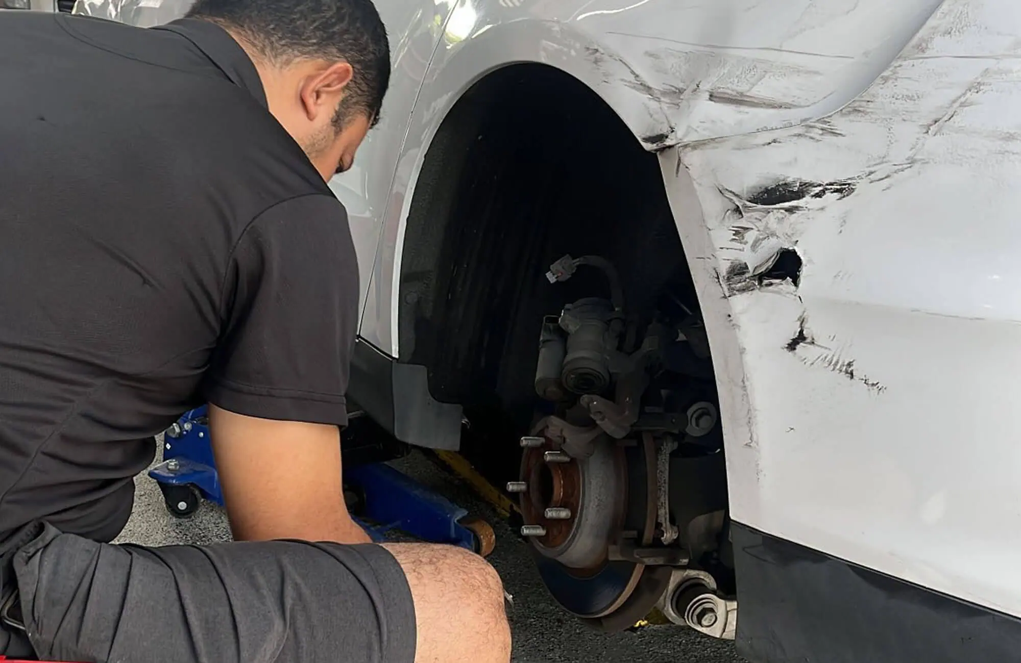 man changing car brake